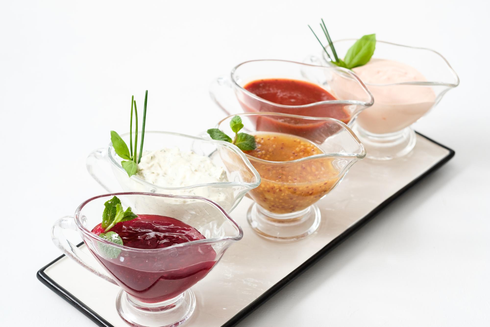 Workshop group tasting sauces at long table